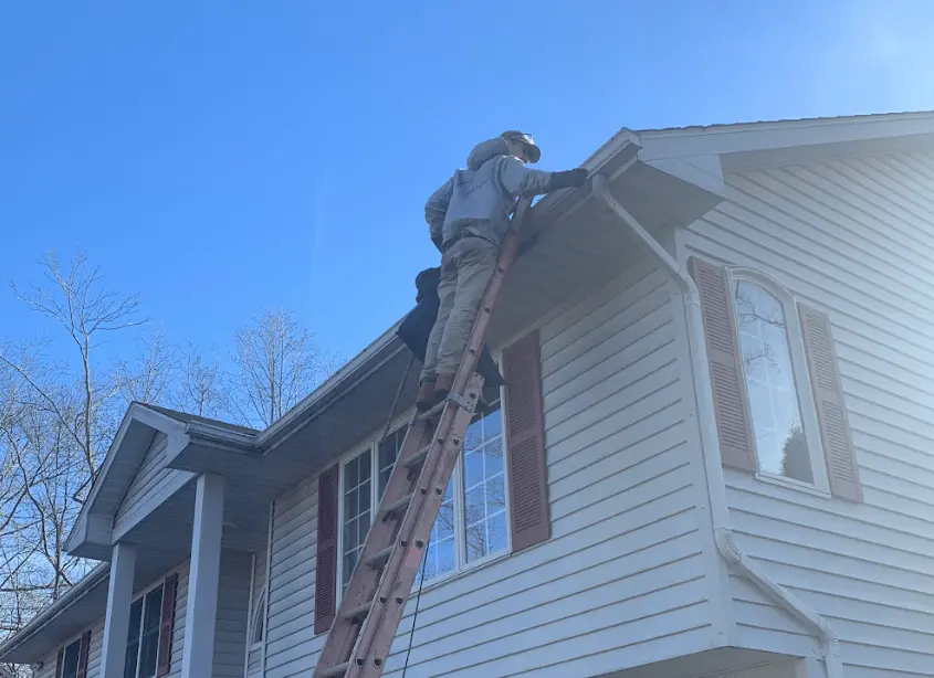 Gutter cleaning and maintenance being performed by Mentor Power Washing in Mentor